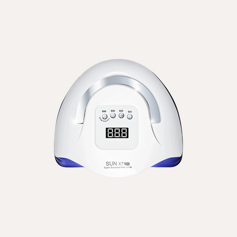 White nail dryer with digital display on a beige background